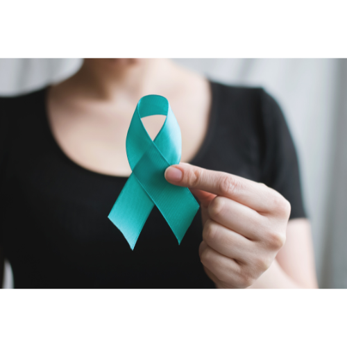 Woman holding a teal ribbon in honor of Sexual Assault Awareness & Prevention Month